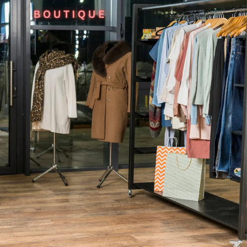 interior of fashion boutique store with clothes and carry bags
