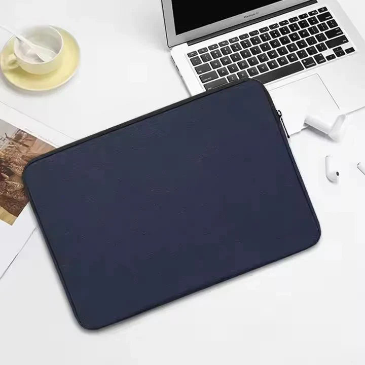 James&Co black laptop sleeve against computer