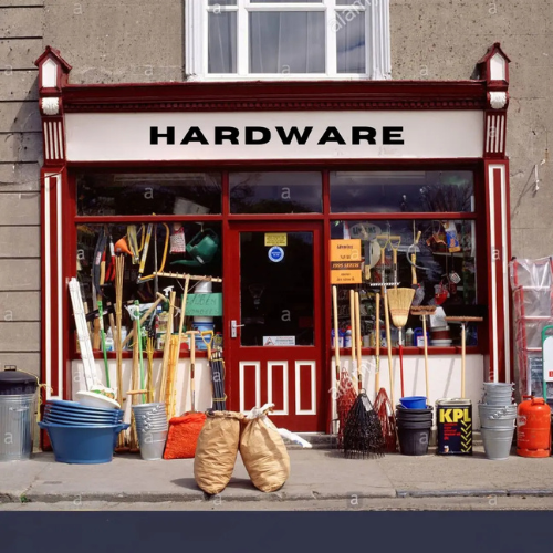 Hardware store front with various tools and equipment displayed outside.